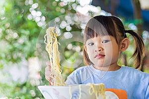 PortraitÃ¢â¬â¹ imageÃ¢â¬â¹ ofÃ¢â¬â¹ 2-3 yearsÃ¢â¬â¹ oldÃ¢â¬â¹ ofÃ¢â¬â¹ baby.Ã¢â¬â¹ HappyÃ¢â¬â¹ AsianÃ¢â¬â¹ childÃ¢â¬â¹ girlÃ¢â¬â¹ enjoyÃ¢â¬â¹ eatingÃ¢â¬â¹ someÃ¢â¬â¹ photo